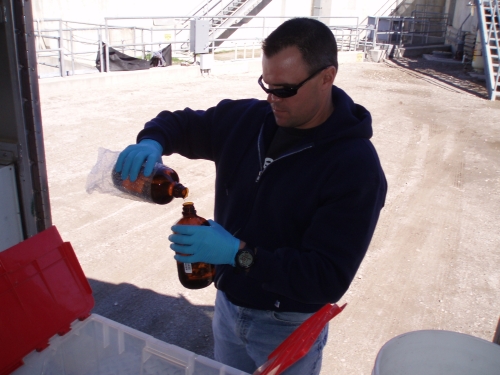 Tommy Liddell pouring a field blank sample at the Santa Clara River Mass Emission Monitoring Site (Feb. 2007)